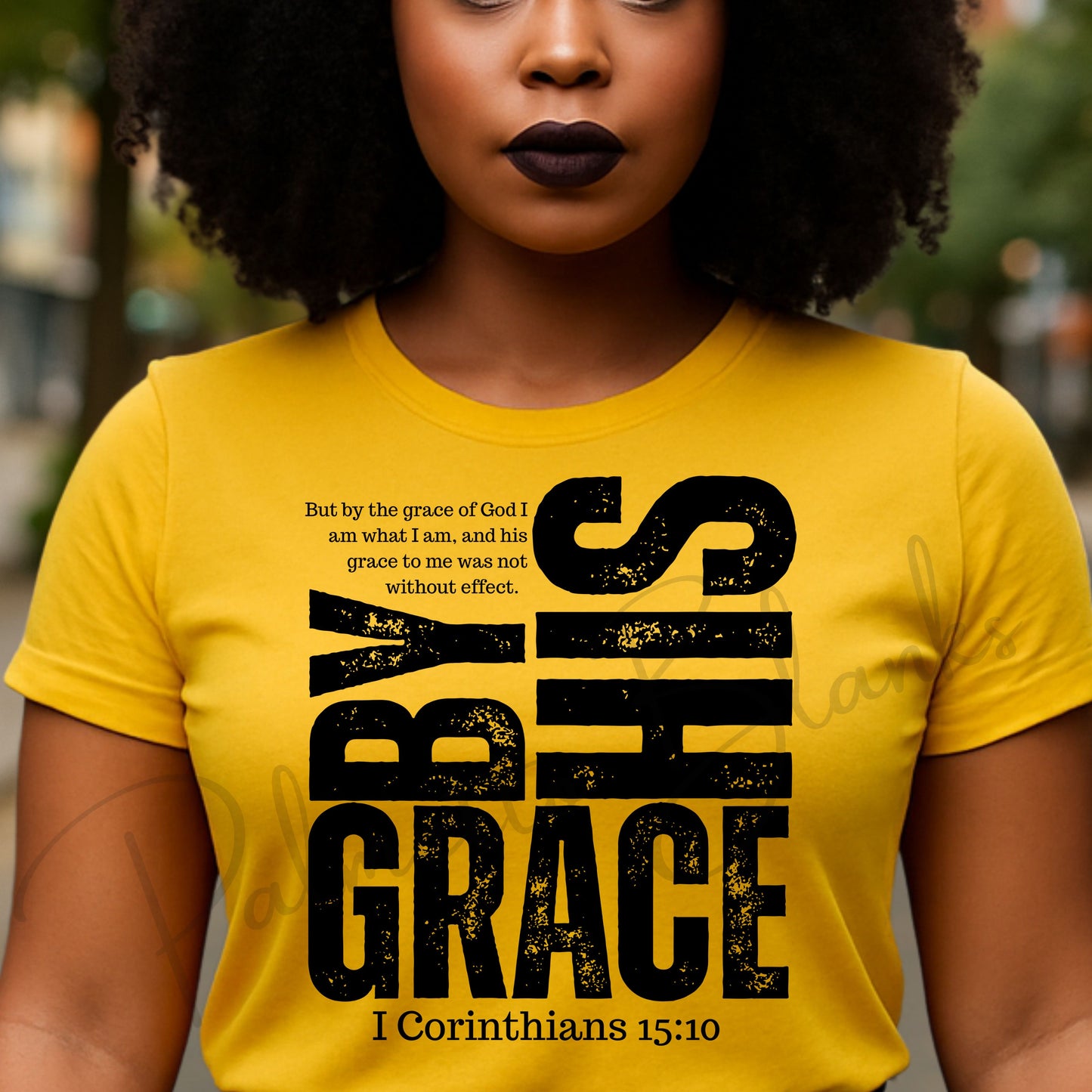 “By His Grace” 1 Corinthians 15:10 white distressed scripture design on a black t-shirt, ideal for screen print transfers.