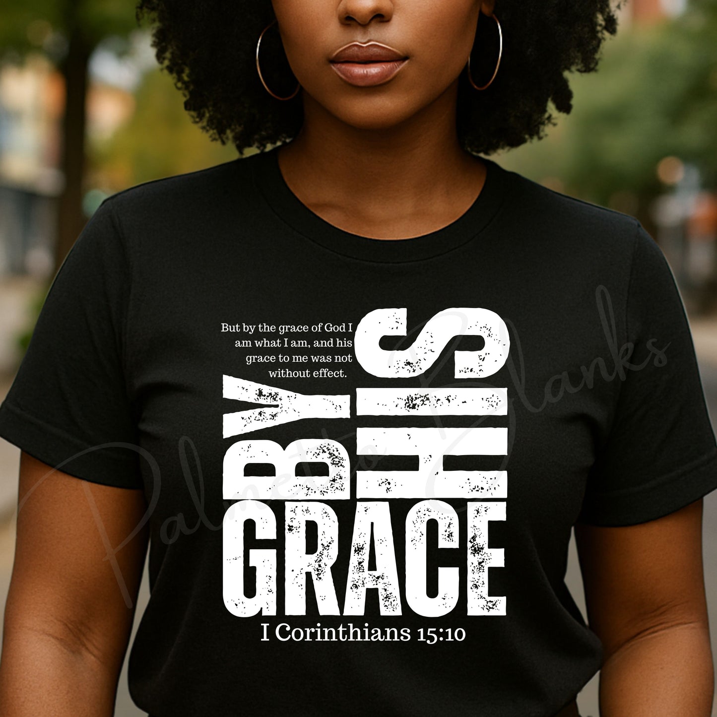 “By His Grace” 1 Corinthians 15:10 white distressed scripture design on a black t-shirt, ideal for screen print transfers.