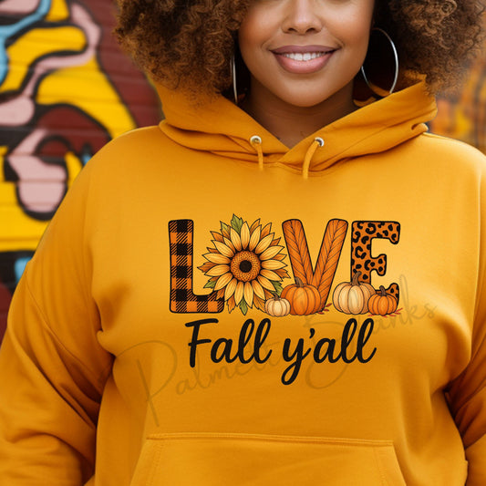 Mustard hoodie featuring the “LOVE Fall Y’all” design with patterned letters, sunflower, pumpkins, and fall-themed accents in full color screen print style.